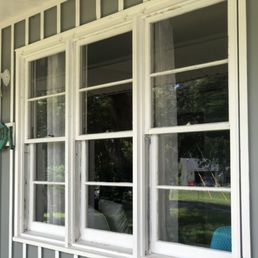 Three washed double-hung windows on a porch